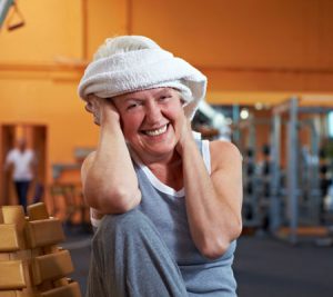 Elderly Woman with a gym towel wrapped around her head while smiling